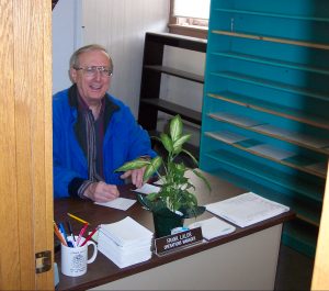 Photo of Frank at his desk in Old Brick