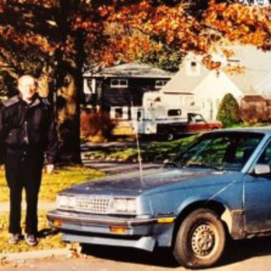 Frank Lalor stands next to an old food rescue vehicle.