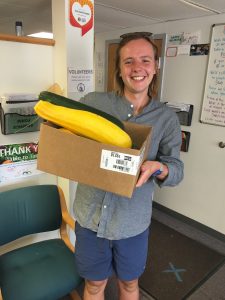 Ezra holding a box of squash