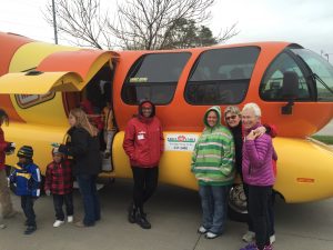 Mary Palmberg with group in front of Oscar Mayer Weinermobile