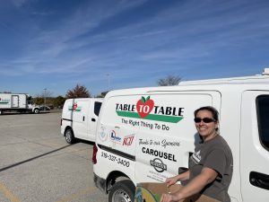 Vicki Jaeger stands next to a Table to Table van