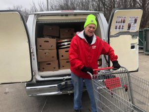 Al Stang loads rescued food into a Table to Table van.