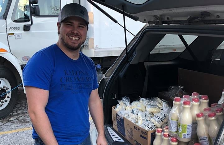 Robert with Kalona Creamery delivers a donation of milk and cheese curds