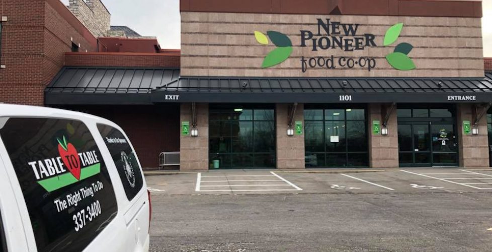 A T2T van is parked outside a New Pioneer store location