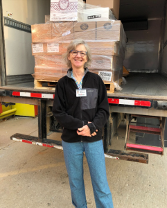 Dina Janzen stands next to the "Big Truck" during a route