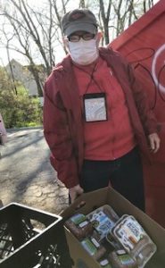 Kenn poses with a box of food.