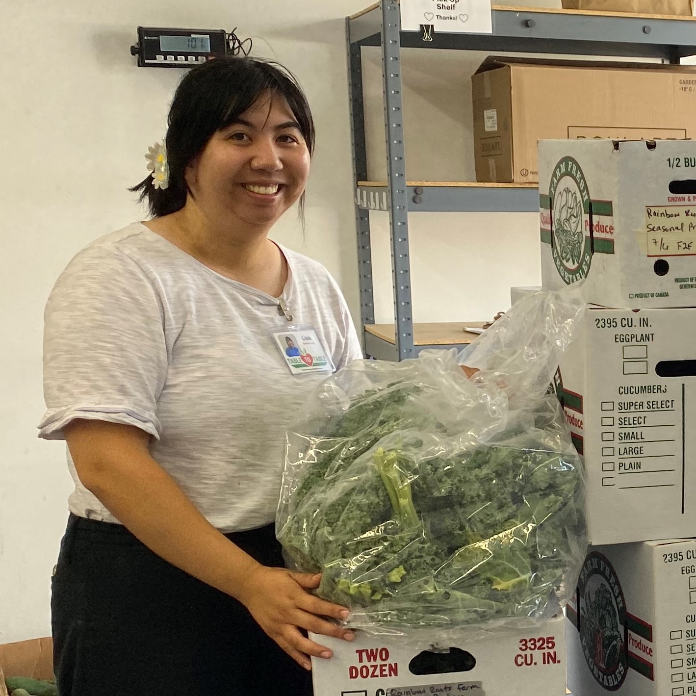 Lisa Truong holds a bag of kale