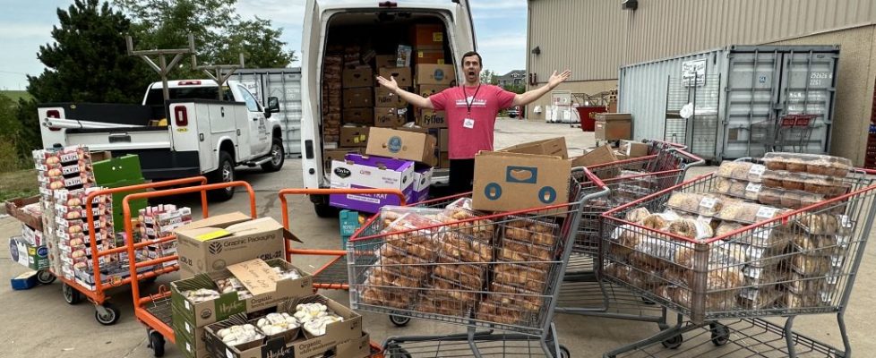 Volunteer in front of T2T van with lots of overflowing shopping carts.