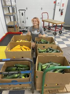 Emma with zucchini donation from Wasson in the workshop.