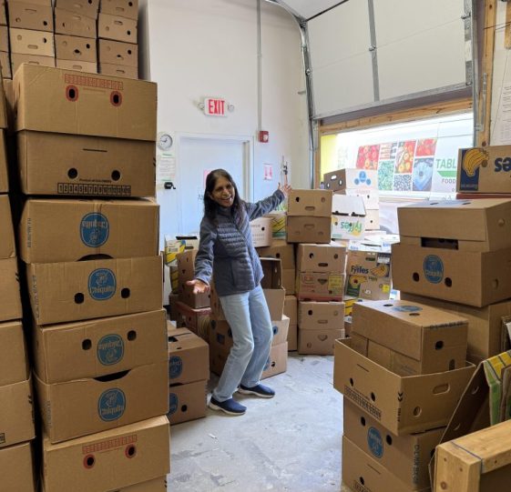 Volunteer Rajni Vijh amongst many banana boxes in the T2T shop.