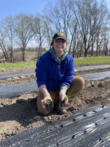 Natalie with plant starts at Grow Johnson County farm.