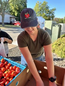 Natalie putting out food at a free produce stand.
