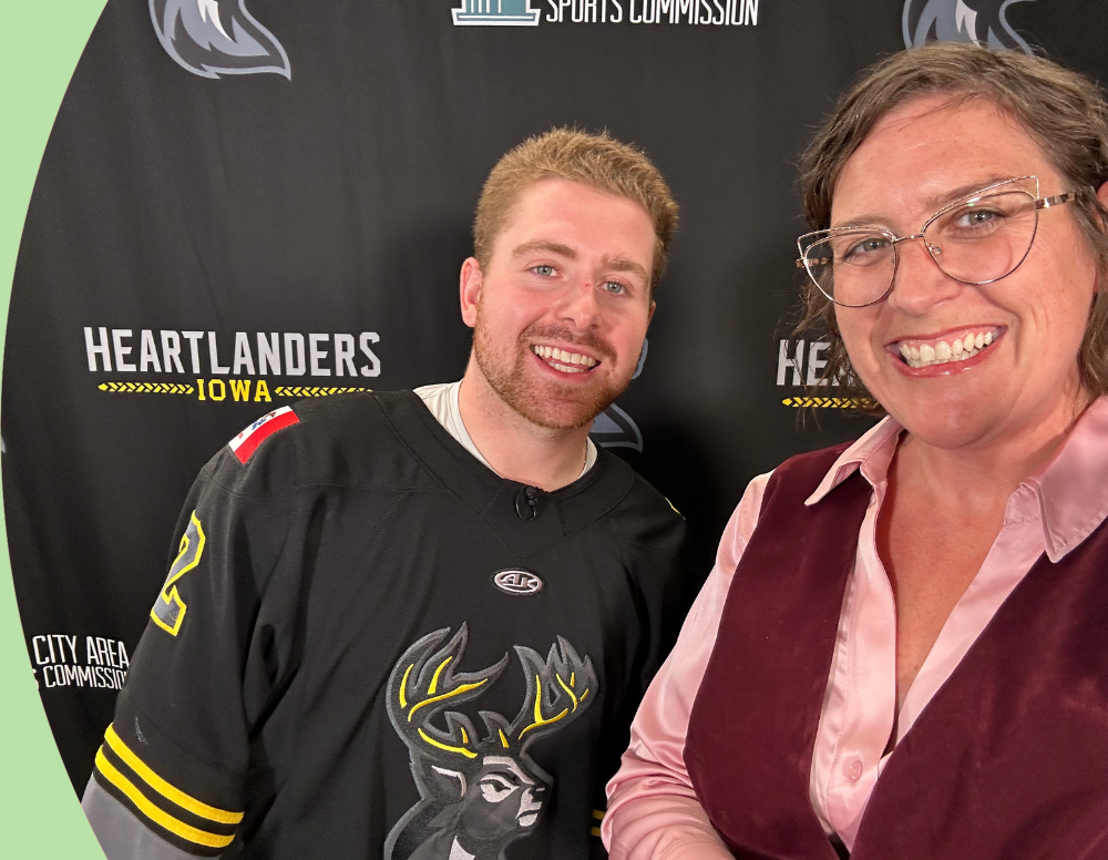 Executive director Nicki Ross posing with heartlanders player.